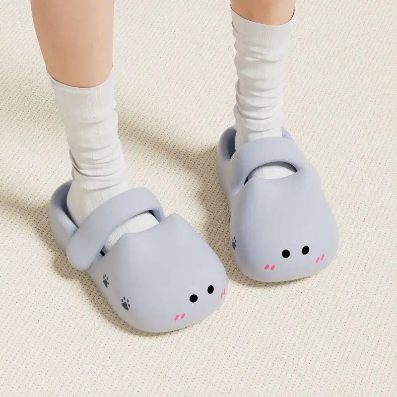Someone in white socks wears KittyNook Cat Co. Adorable Cat Face Comfort Sandals on a light floor.