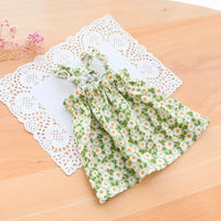 Thumbnail for KittyNook Cat Co. Summer Cotton Cat Dress with white daisies, shown on a lace doily for breezy comfort.