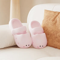Thumbnail for KittyNook Cat Co.'s Adorable Cat Face Comfort Sandals in pink with non-slip sole rest on a white sofa by a brown cushion.
