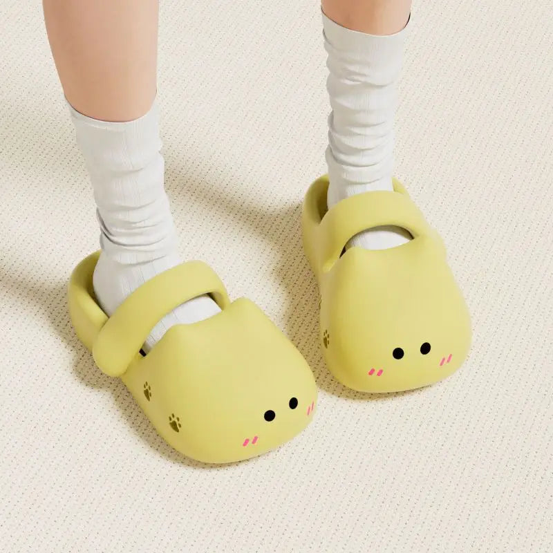 Person wearing KittyNook Cat Co. Adorable Cat Face Comfort Sandals with white socks on a textured floor.