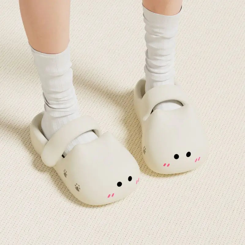 Person wearing white socks and KittyNook Cat Co. Adorable Cat Face Comfort Sandals with non-slip soles.