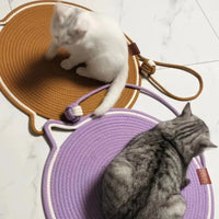 Thumbnail for Two cats lounge on Tails Cat Scratching Mats by KittyNook, a brown and a purple one, protecting the white floor.