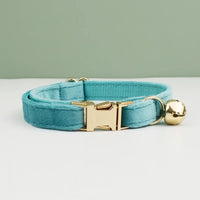 Thumbnail for KittyNook Cat Co. Velvet Cat Collar in light blue with gold buckle & bell, shown on a white surface.