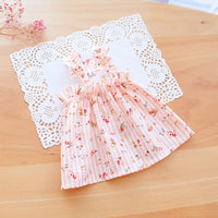 Thumbnail for The KittyNook Cat Co. Summer Cotton Cat Dress, in pink floral with ruffles, is displayed on a white doily.