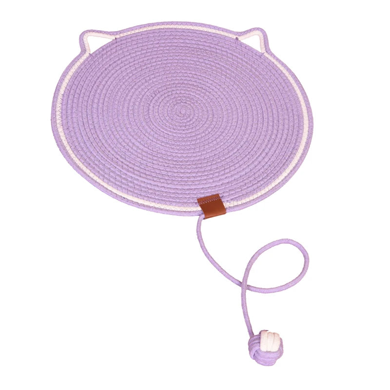 The Tails Cat Scratching Mat by KittyNook Cat Co. is a lavender circular mat with loops and a knotted ball string.