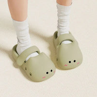 Thumbnail for Someone wearing KittyNook Cat Co.’s Adorable Cat Face Comfort Sandals with white socks on a light carpet.