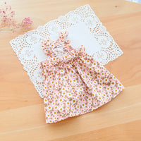 Thumbnail for The KittyNook Cat Co. Summer Cotton Cat Dress features pink florals and ruffled sleeves, displayed on a white doily.