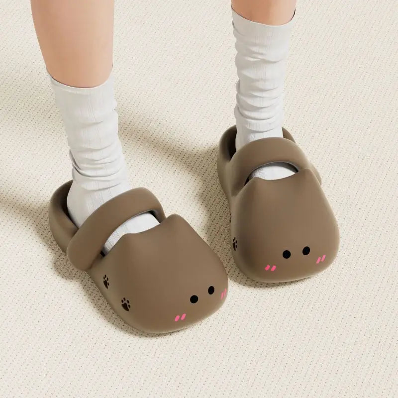 Person wears white socks and KittyNook Cat Co. Adorable Cat Face Comfort Sandals with cute faces and non-slip soles.