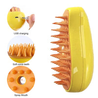 Thumbnail for KittyNook Cat Co. Electric Cat Grooming Brush: yellow, orange soft teeth, spray nozzle, USB charging port.