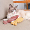 A ragdoll cat with Linen Catch Fish Toy in red and yellow