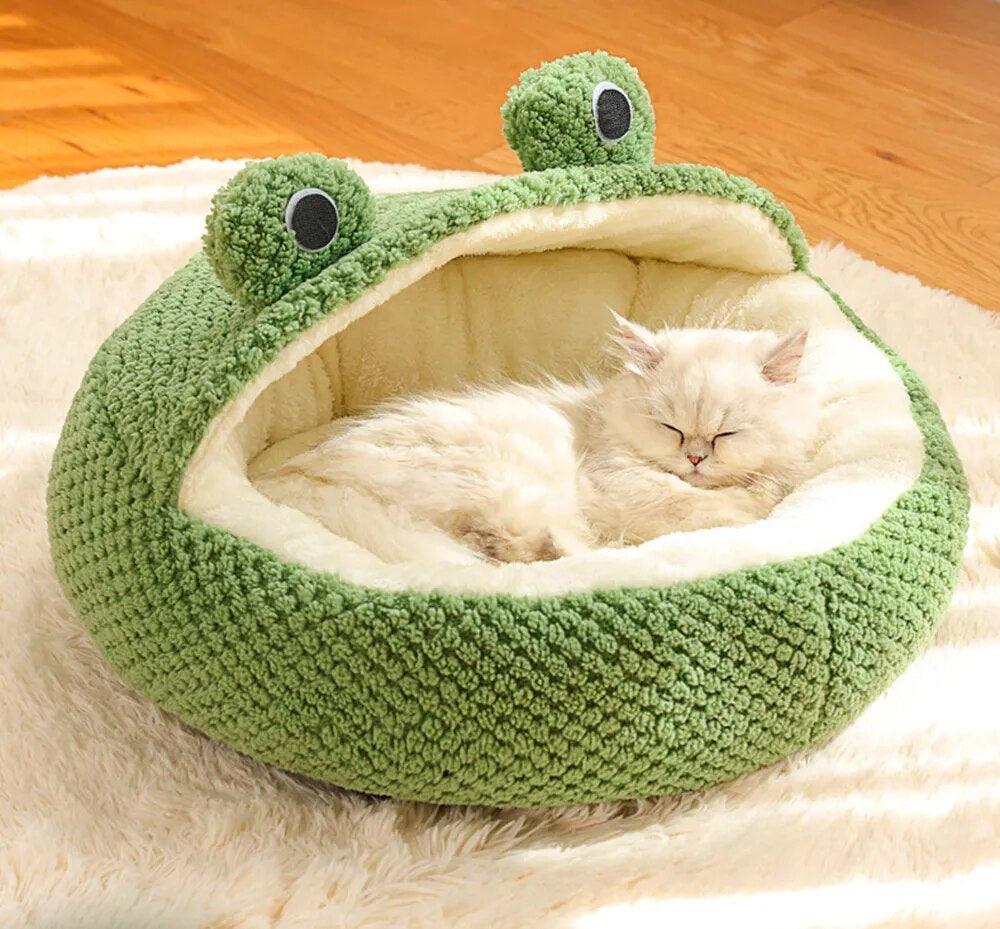 a white cat sleeping inside the Hoppin Haven Cool Cat Bed in half cave variant