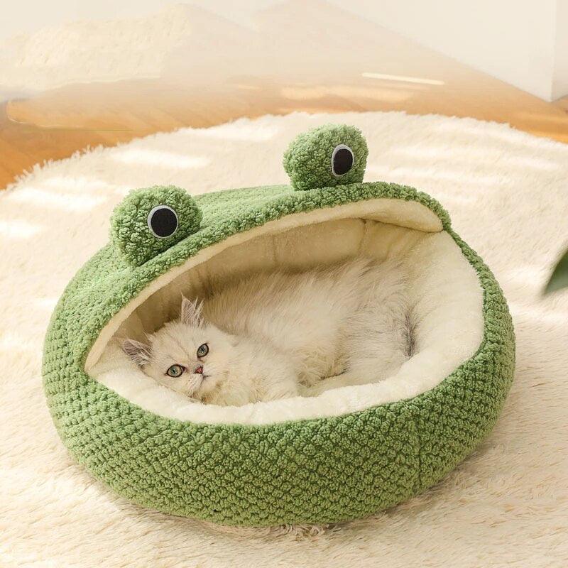 a white persian cat lying down in a Hoppin Haven Cool Cat Bed in half cave variant. she looks straight in the camera