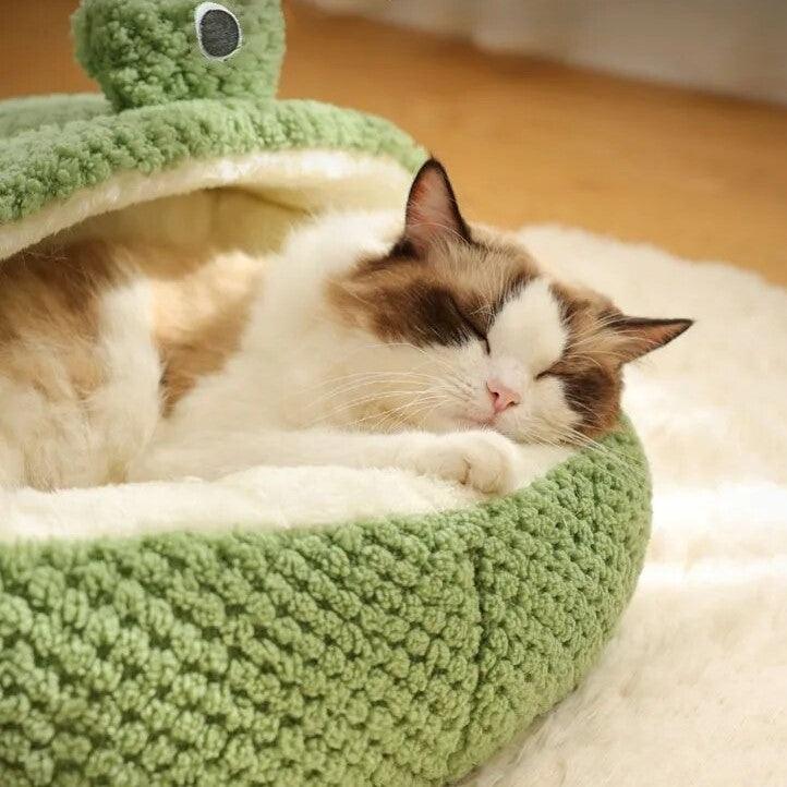 A ragdoll cat sleeping comfortably inside a Hoppin Haven Cool Cat Bed half cave variant