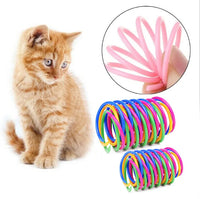 Thumbnail for Orange kitten plays with KittyNook Cat Co. Colorful Spiral Spring Cat Toy Pack; hand holds pink spring close-up.