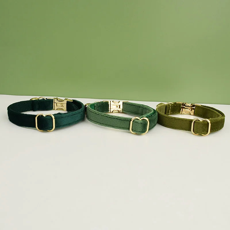 Three Velvet Cat Collars by KittyNook Cat Co., luxuriously soft, shown on white with a green background.