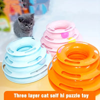 Thumbnail for Gray kitten eyes the KittyNook Cat Co. 3-Layer Interactive Cat Toy Tower with Balls: blue, pink, orange on white.