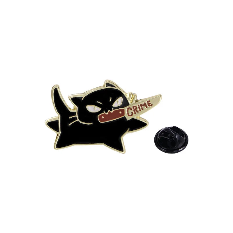KittyNook Cat Co.'s Cute Black Cat Enamel Brooch features an angry cat with a "CRIME" knife and pin backing.