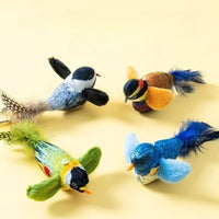 Thumbnail for Four Ultimate Interactive Chirping Bird Cat Toys by KittyNook Cat Co. are arranged on a light yellow background.