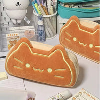 Thumbnail for Two KittyNook Cat Co. Caramel Cat Plush Pencil Cases on a desk with cute notebooks and playful plush school supplies.