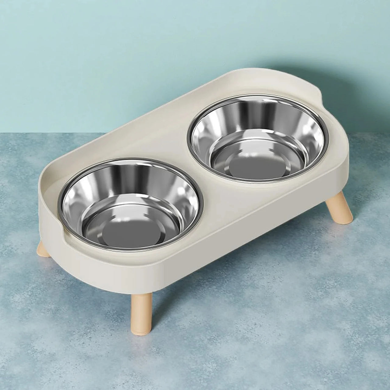 The KittyNook Cat Co. Dopamine DuoLift Colorful Cat Feeder has double stainless bowls in a white holder on wooden legs.