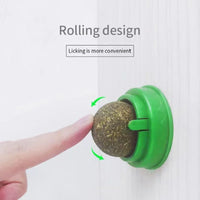 Thumbnail for A hand touches a Stick-On Natural Catnip Ball by KittyNook Cat Co. with 