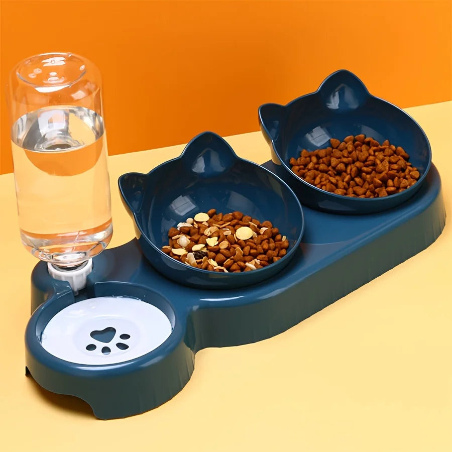KittyNook Cat Co. Cute 3 In 1 Cats Bowls With Water Feeder and paw-print dish on a yellow surface.