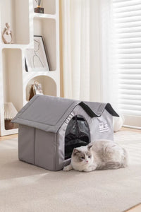 Thumbnail for A white and grey cat relaxes by the KittyNook Cat Co. Portable Pet Cooling House in a bright, modern living room.
