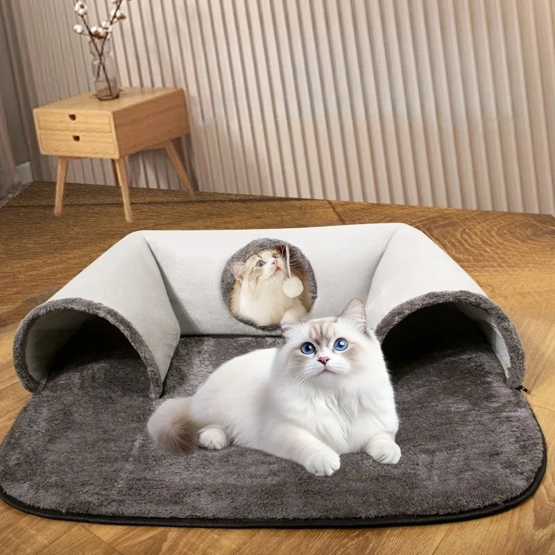 Two fluffy cats play with the KittyNook Cat Co. Interactive U-shaped Cat Tunnel, one inside and one on the soft mat.