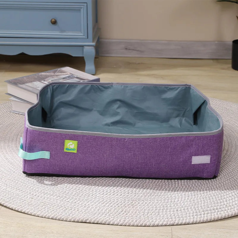 A purple and gray pet bed is by a blue cabinet with books, near a KittyNook Cat Co. Portable Cat Litter Box.