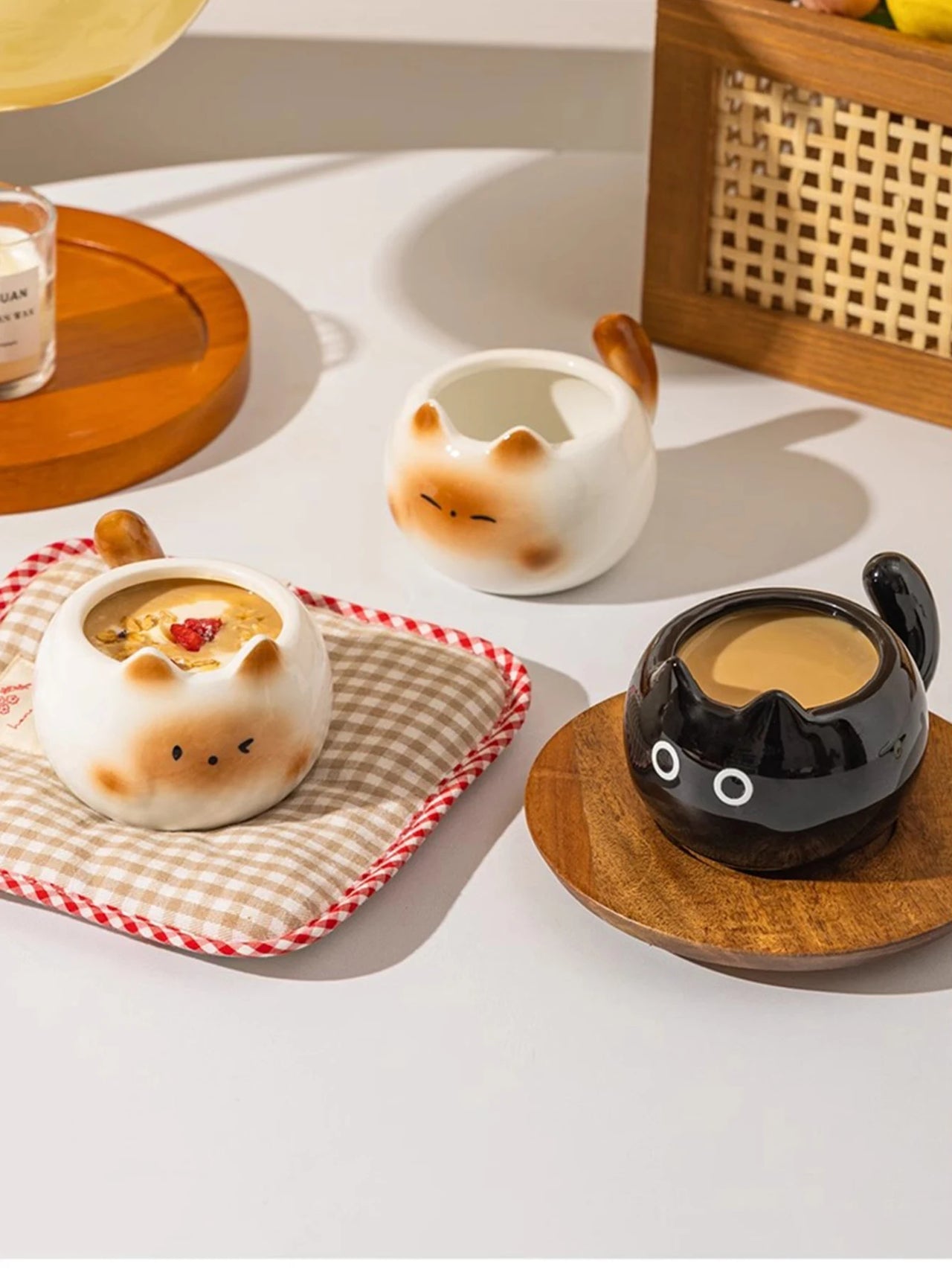 Three Siamese Cat Coffee Cups by KittyNook Cat Co., two white and one black, filled with drinks and dessert.