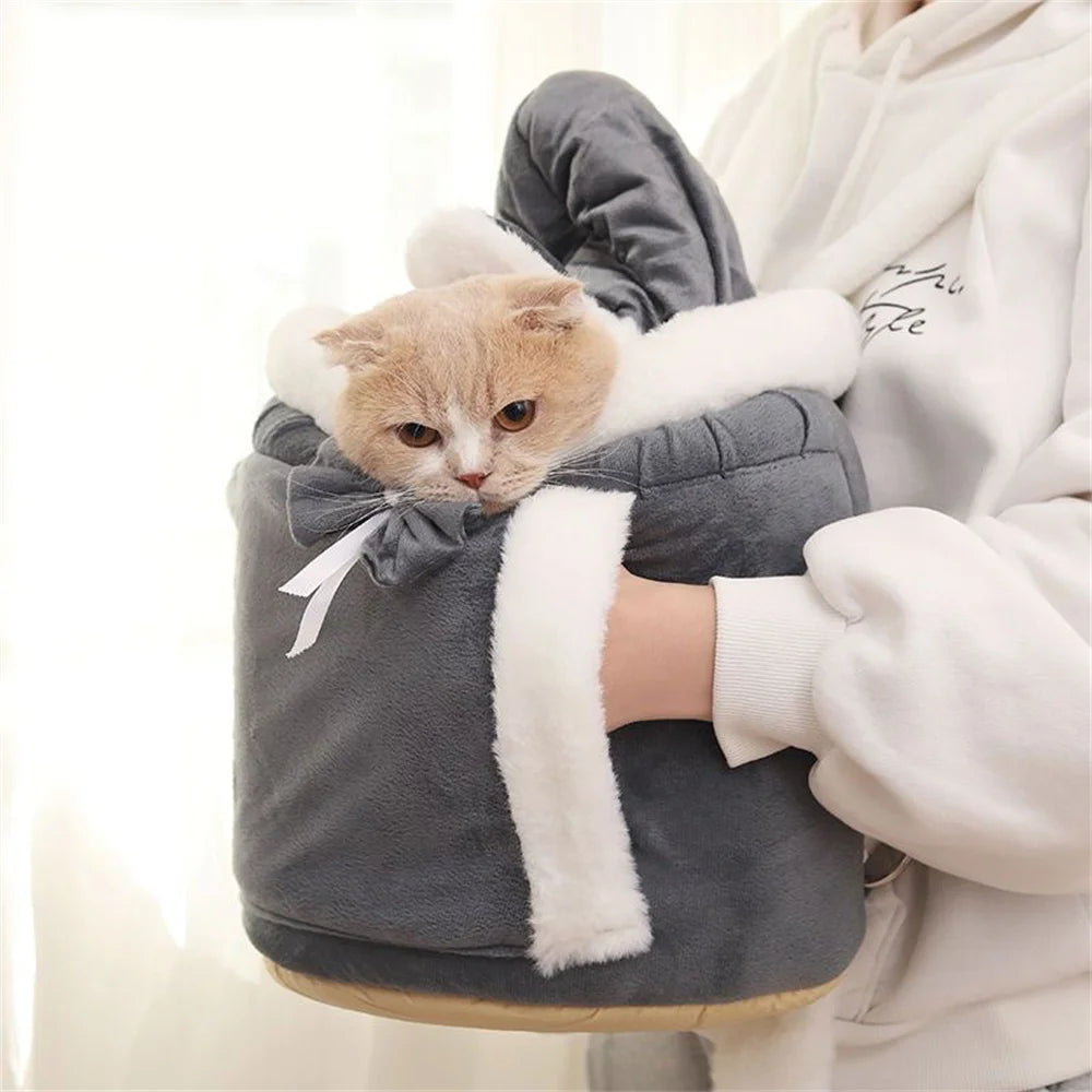 A cat relaxes in The Stylish Pet Travel Bag by KittyNook Cat Co., perfect for hands-free travel with your feline friend.