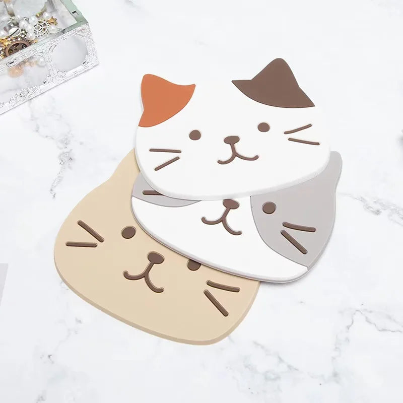 KittyNook Cat Co. Cat Silicone Cup Coaster Mats feature cute faces and are heat-resistant, non-slip, and stylish.