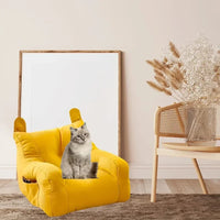 Thumbnail for A gray cat lounges on the KittyNook Cat Co. Cat Cartoon Sofa Bed with ear-shaped cushions in a stylish, cozy room.