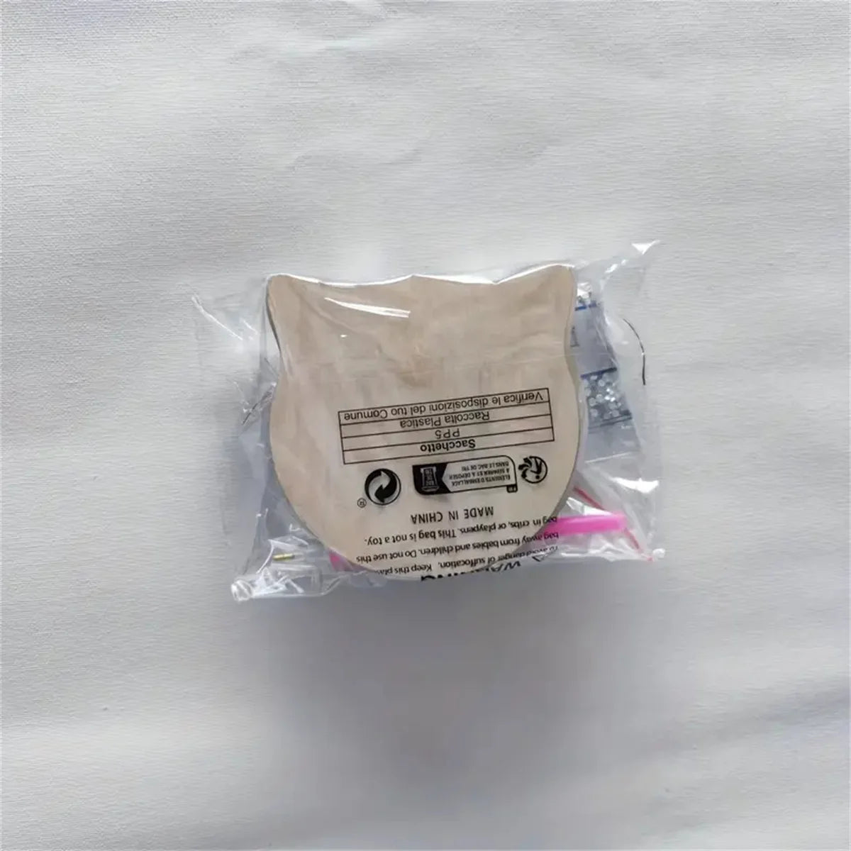 A sealed clear bag holds KittyNook Cat Co. DIY Cat Sparkle Mosaic Drink Coasters (6-Pack) on a white surface.