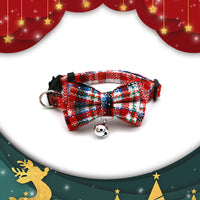 Thumbnail for KittyNook Cat Co. Christmas Mini Collar for Cats: red plaid with bow tie and bell on a gold-accented festive background.