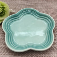Thumbnail for Light blue Extra Wide Raised Flower Cat Bowl by KittyNook Cat Co. on a textured surface, flower-shaped and elevated.