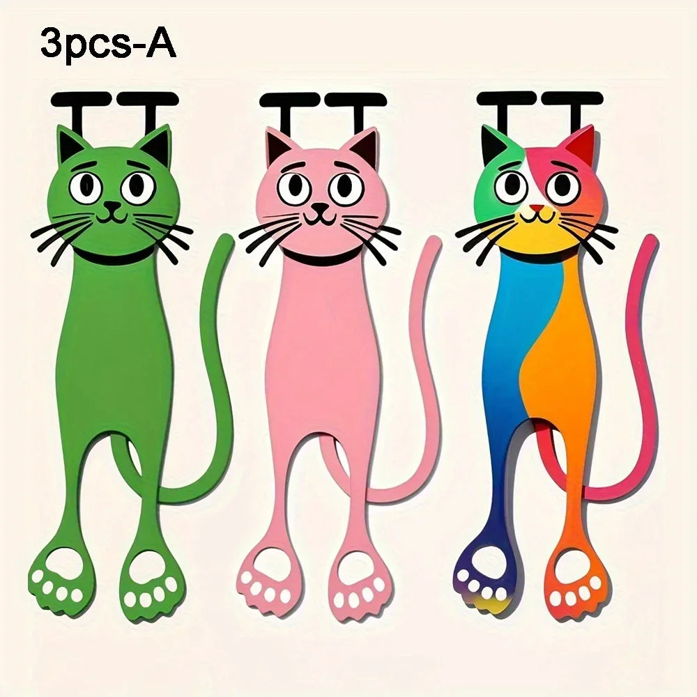 Three Sleek Flat Cat Acrylic Bookmarks by KittyNook Cat Co. in green, pink & multicolor rest side by side on display.