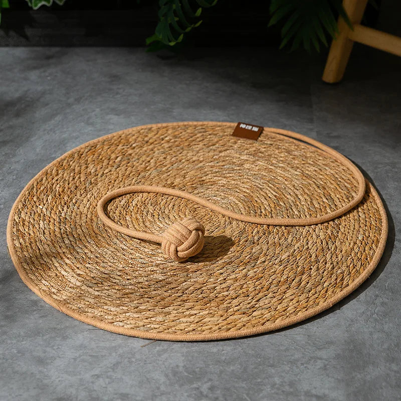 The KittyNook Cat Co. Natural Rattan Cat Scratcher offers eco-friendly feline fun with a rope toy for added play.