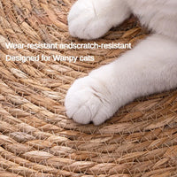 Thumbnail for Close-up of a white cat's paws on a woven mat with the KittyNook Cat Co. Natural Rattan Cat Scratcher for happy cats.