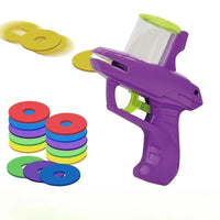 Thumbnail for KittyNook Cat Co. Turnip Launcher interactive cat toy with colorful foam discs scattered and stacked on white background.