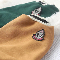 Thumbnail for Close-up of KittyNook Cat Co. Cozy Fluff Cat Sweater—green/brown knits with striped collars and crest patches.