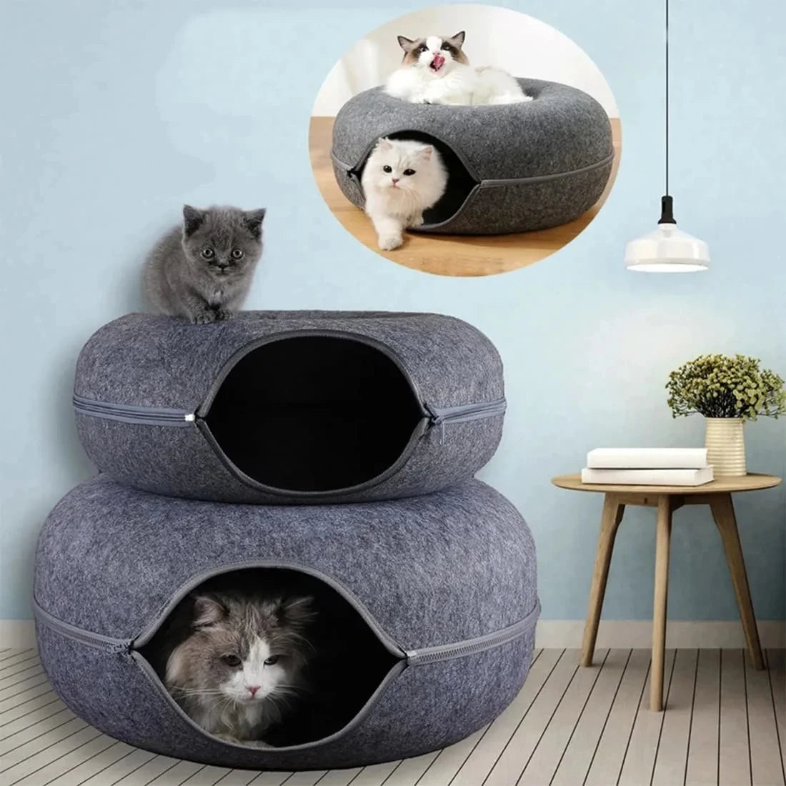 Two Orbital Lounge & Play Tunnel Beds by KittyNook Cat Co. are stacked, with cats lounging amid modern decor and wall art.