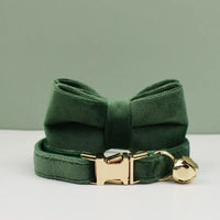 Thumbnail for KittyNook Cat Co. Velvet Cat Collar features a bow, gold buckle, bell, and comfy fit on a matching green backdrop.