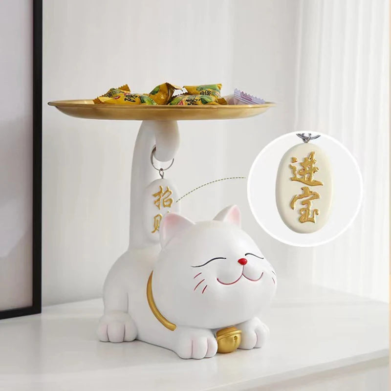 The Chic Cat Metal Key Tray by KittyNook Cat Co. holds candies and keys, featuring a gold pendant with Chinese characters.