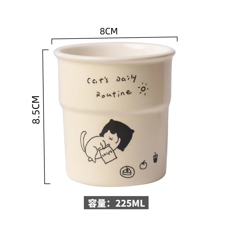 KittyNook Cat Co. Cute Illustrated Ceramic Cat Mug, cream, 8cm wide, 8.5cm tall, 225ml, says “Cat’s Daily Routine”.
