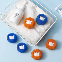 Thumbnail for Six bear-shaped sponges, blue and orange, with The Laundry Pet Hair Filter by KittyNook Cat Co., in a white basket on blue.