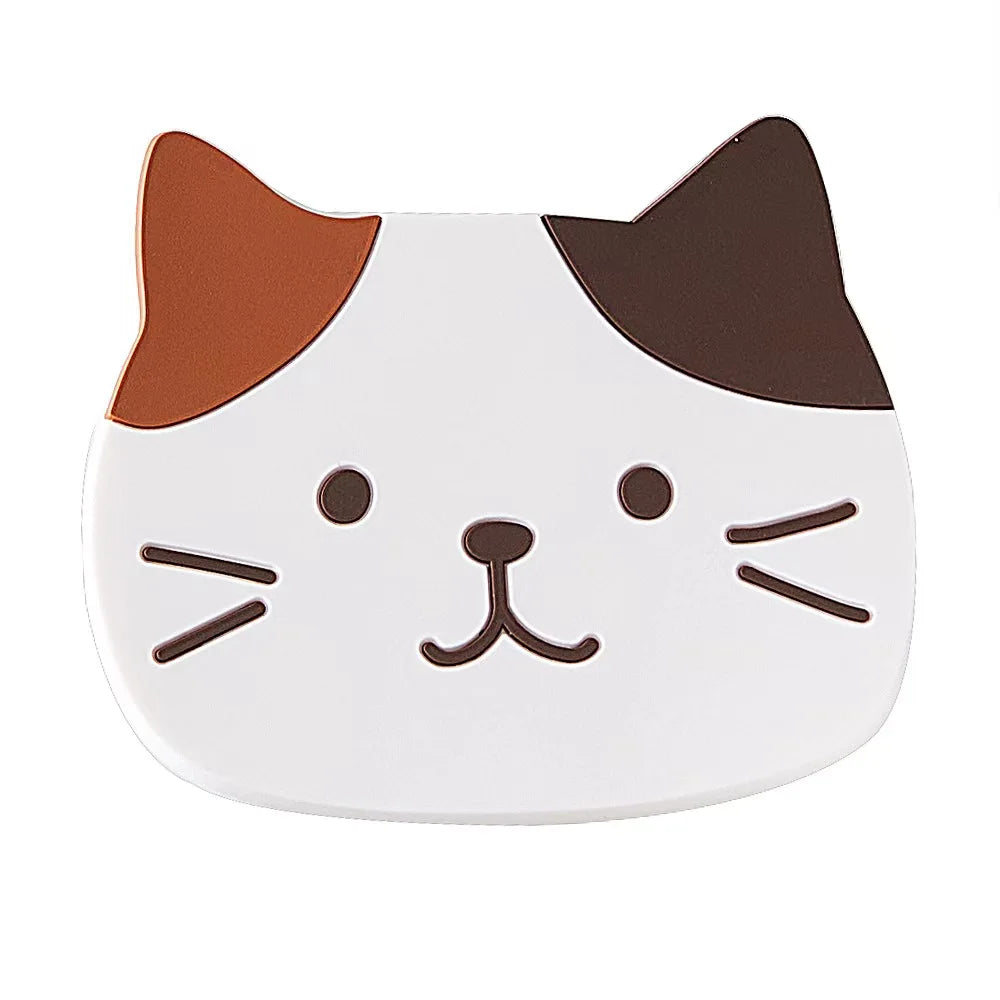 The Cat Silicone Cup Coaster Mat by KittyNook Cat Co. features a cartoon cat face and non-slip design for cups.