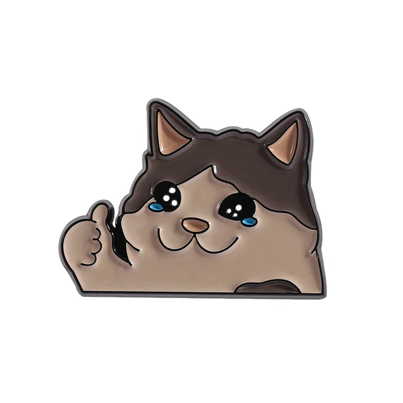 KittyNook Cat Co. Kawaii Thumbs Up Crying Cat Enamel Pin: brown & cream, big eyes, smiles on white background.