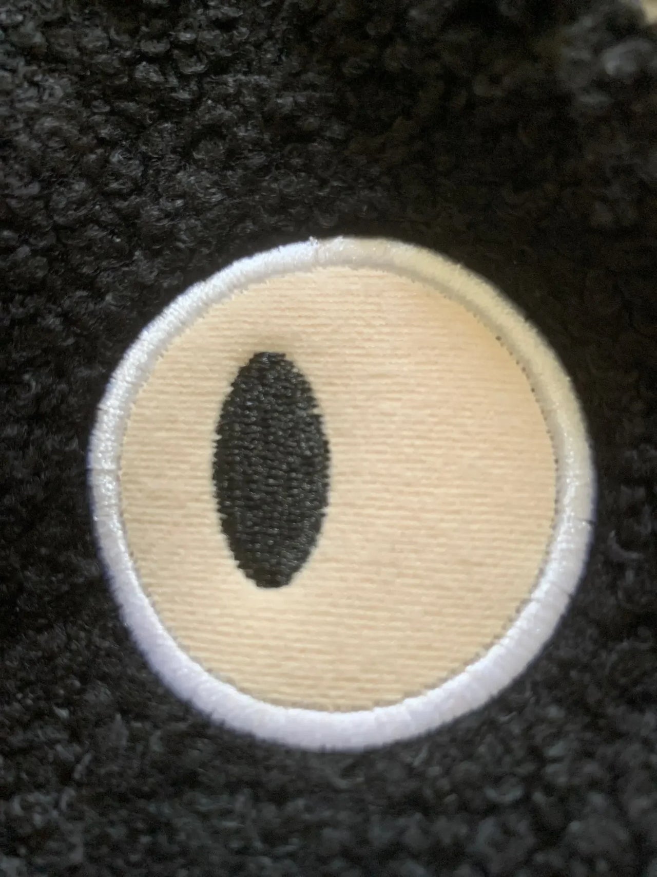 Close-up of the Neko Soft Cat Shoulder Bag’s embroidered eye by KittyNook Cat Co. on a white background.