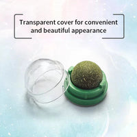 Thumbnail for A green round Stick-On Natural Catnip Ball for Cats by KittyNook Cat Co., shown open on a pastel background with text.
